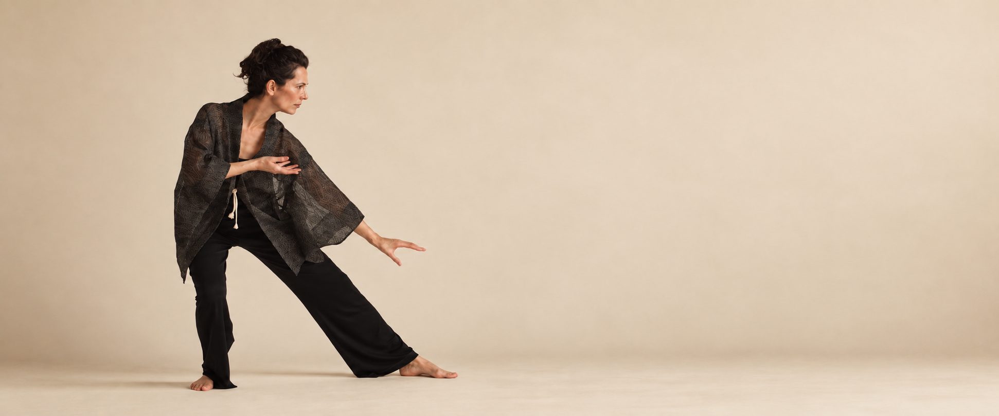 Wendy-Joyce in a low Tai Chi stance in the studio